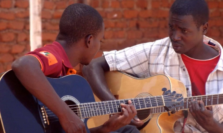 Guitar lessons at Music Crossroads Malawi. Photo: Facebook