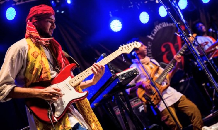 Egyptian guitarist Mohamed Kamal on stage with the Nile Project in Nairobi, Kenya. Photo: Quaint Photography