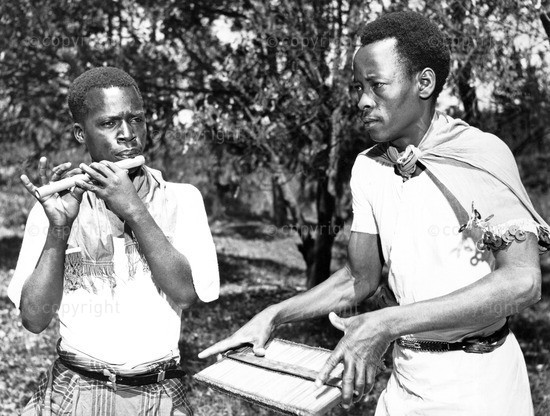 Kenyan musicians playing side-blown flute and Kayamba raft rattle. Photo: www.http://ilam.africamediaonline.com/