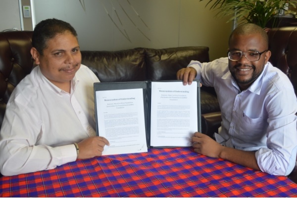 Andre Le Roux and Eddie Hatitye with the MoU between the SAMRO Foundation and the Music In Africa Foundation.