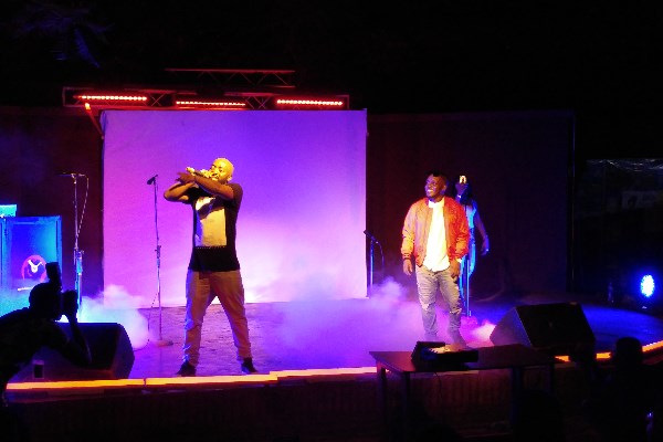 MI Abaga, right, looks on as Loose Kaynon performs.