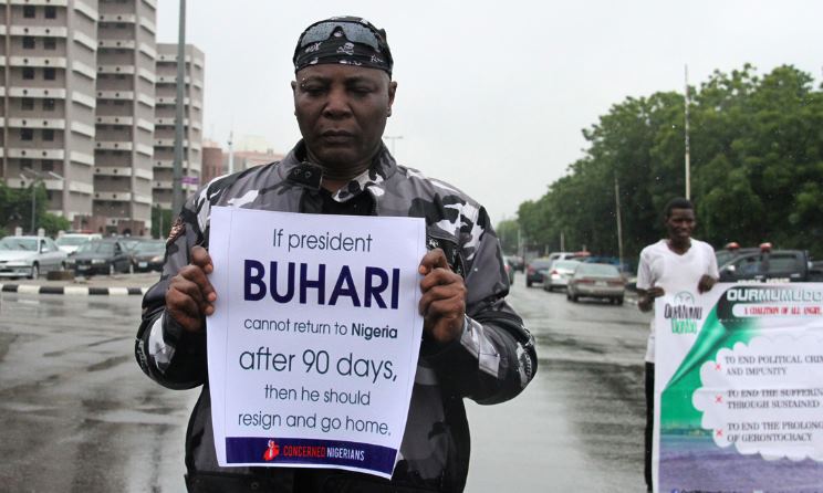 Charly Boy holding a poster demanding the resignation of Nigerian President Muhammadu Buhari. Photo: The Guardian
