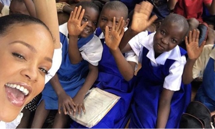 Rihanna takes a selfie with children at a local school in Lilongwe, Malawi.