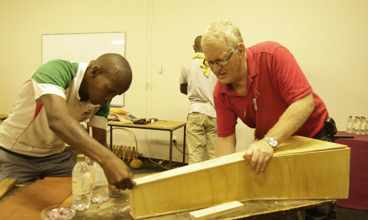 Marimba expert Christian Carver (right) shows a trainee how to make marimba during Music In Africa's Instrument Building and Repair Workshop in 2016.