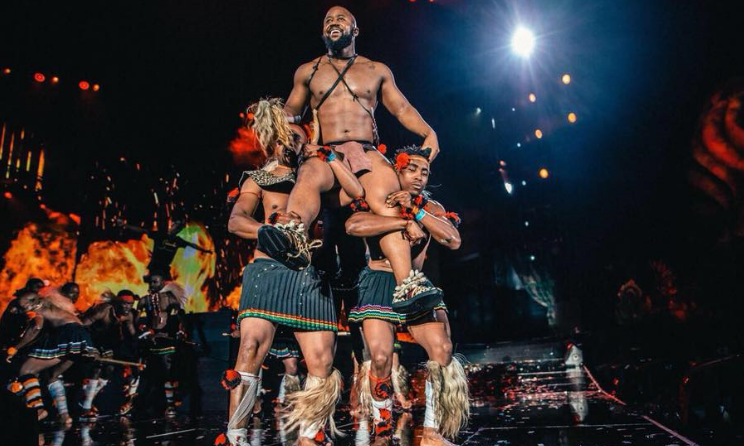 Cassper Nyovest is carried by dancers in traditional South African regalia during this weekend's concert at FNB Stadium in Johannesburg.