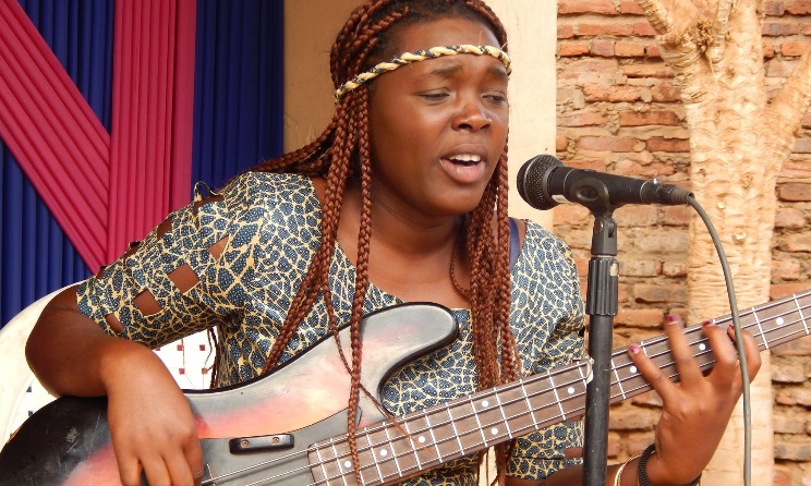 A Music Crossroads Malawi student playing the bass guitar.