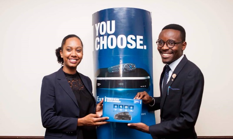 Patience Namadingo (right) receives a DStv decoder at the signing ceremony.