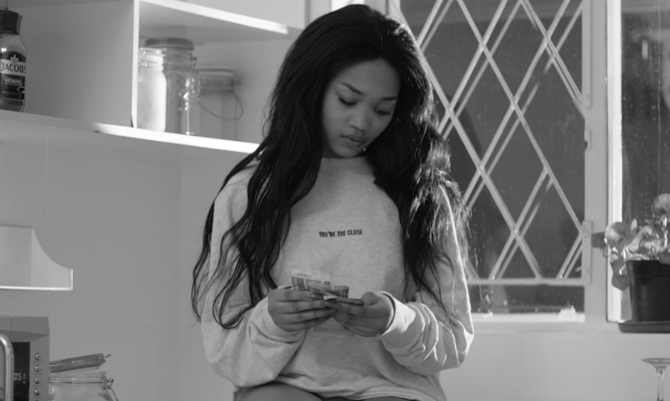The main character counting her hard earned money in 'Push Through the Pain'.