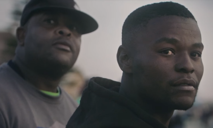 Onlookers in the 'Gasoline' video watch a car spinning in Soweto.