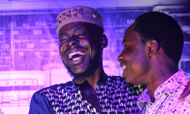 Adekunle Gold shares laugh with guest at Abuja. Photo:CC