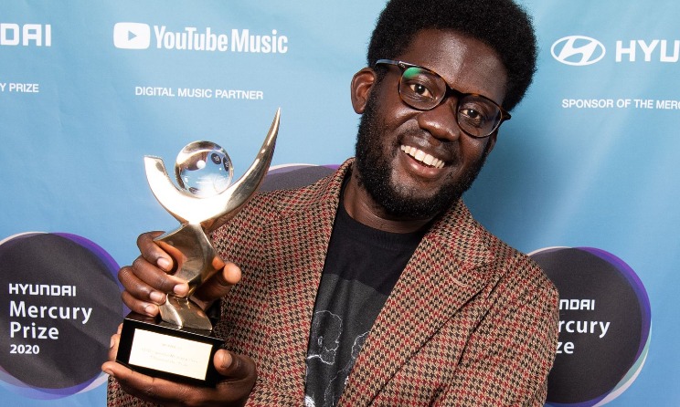 Michael Kiwanuka poses for a photograph with the Mercury Prize.