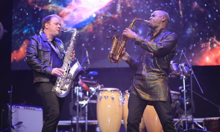 Darren Rahn and Isaiah Katumwa on stage.