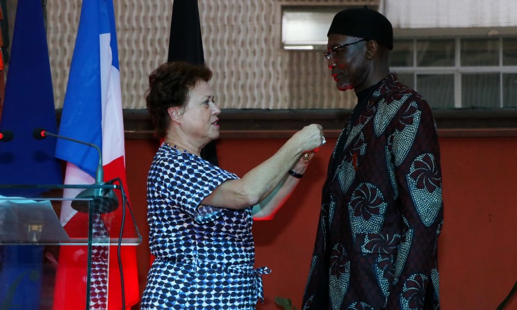 French ambassador Aline Kuster-Menager bestowing the Order of Arts and Letters on producer Tabu Osusa at Alliance Francaise in Nairobi on 16 July. Photo: French Embassy in Kenya and Somalia.