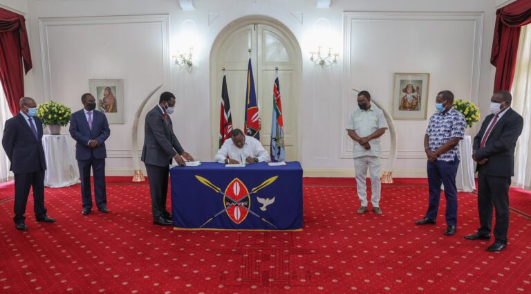 Kenyan President Kenyatta signing bills into laws at State House in Nairobi on 4 April.