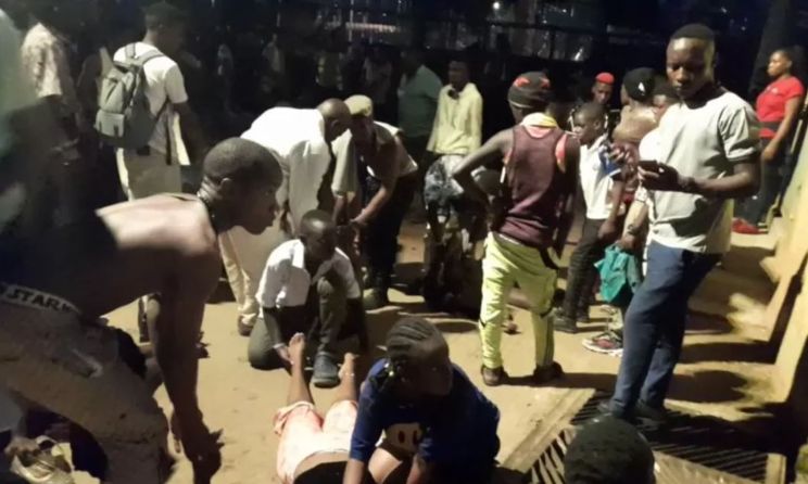 Revellers assisting the injured after a stampede that killed 11 in Ugandan capital Kampala.