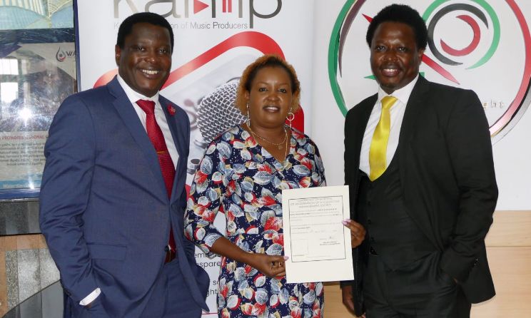 KAMP CEO Maurice Mwande Okoth, chairperson Faith Kithele and vice-chairperson Anthony Musembi pose for a photograph with the new collection licence.