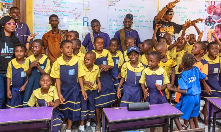 Akoka Primary School pupils pose for a photograph with representatives from the Foster programme in Lagos, Nigeria, on 2 June.