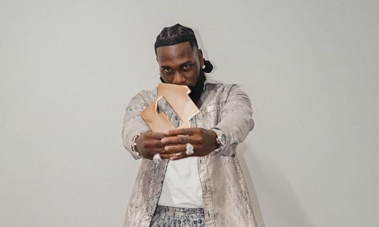 Burna Boy posing with his Official Albums Chart No 1 Award for I Told Them. Credit: The Official Charts Company