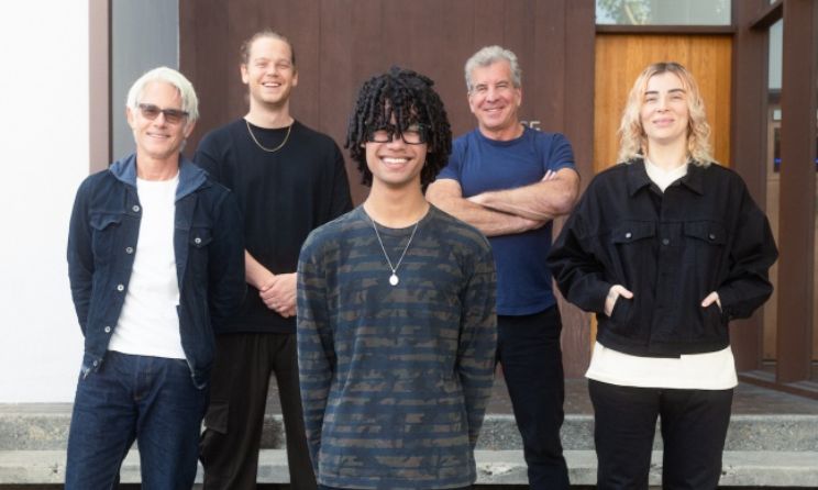 9Lives (front) posing for a photograph with executives from Pulse Records.