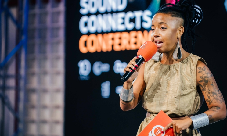 Sound Connects Conference host Filippa Mondlane speaking to the audience in Maputo, Mozambique. Photo: Music In Africa