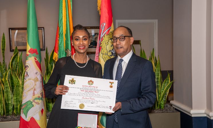 Betty G accepting her award from Ethiopian Crown Council president Prince Ermias Sahle Selassie.