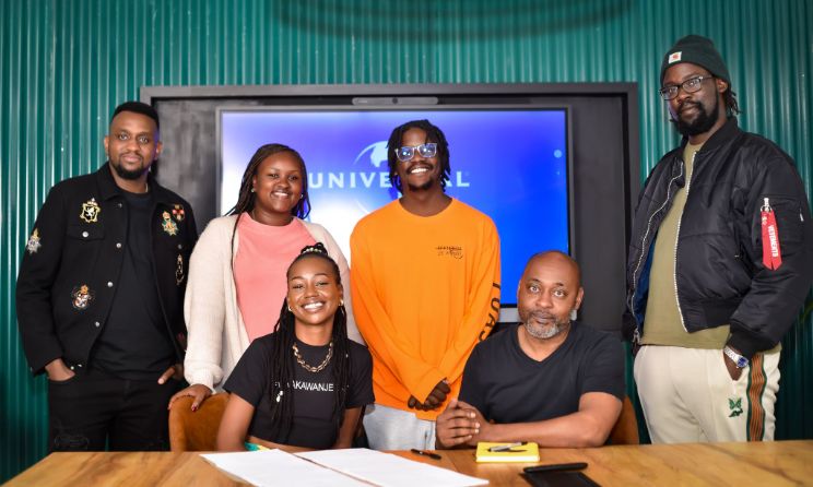 Njerae (seated left) and UMG EA general manager Chinasa Udeala (seated right) during the signing of the deal.
