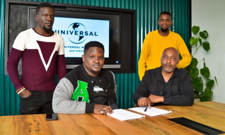 Vic West (seated left) with UMG East Africa general manager Chinasa Udeala during the signing of the deal.