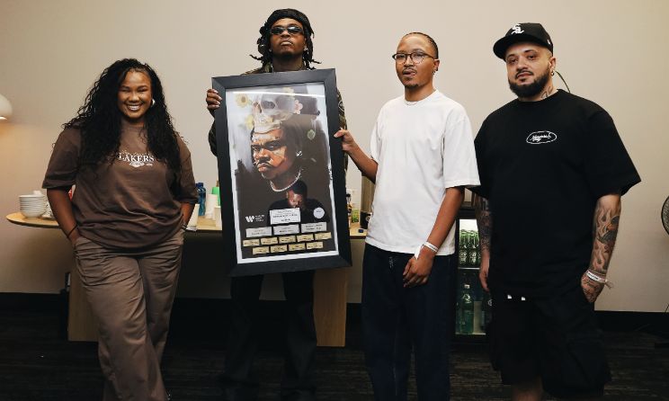 US rapper Gunna holding a plaque.