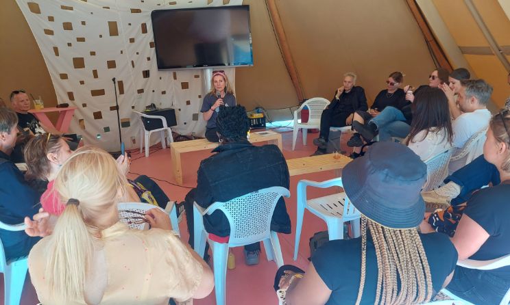 Roskilde Festival head of philanthropy Kara Djurhuus addressing participants in Denmark.