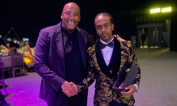 Minister of Sports, Arts and Culture of South Africa pose for a picture with Mphumelelo Dlamini, who won the Outstanding Musician Award.